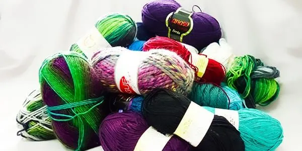 A pile of colorful yarn on a white background.