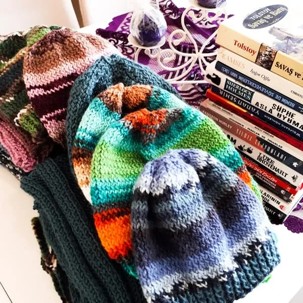 A group of knitted hats on a table.